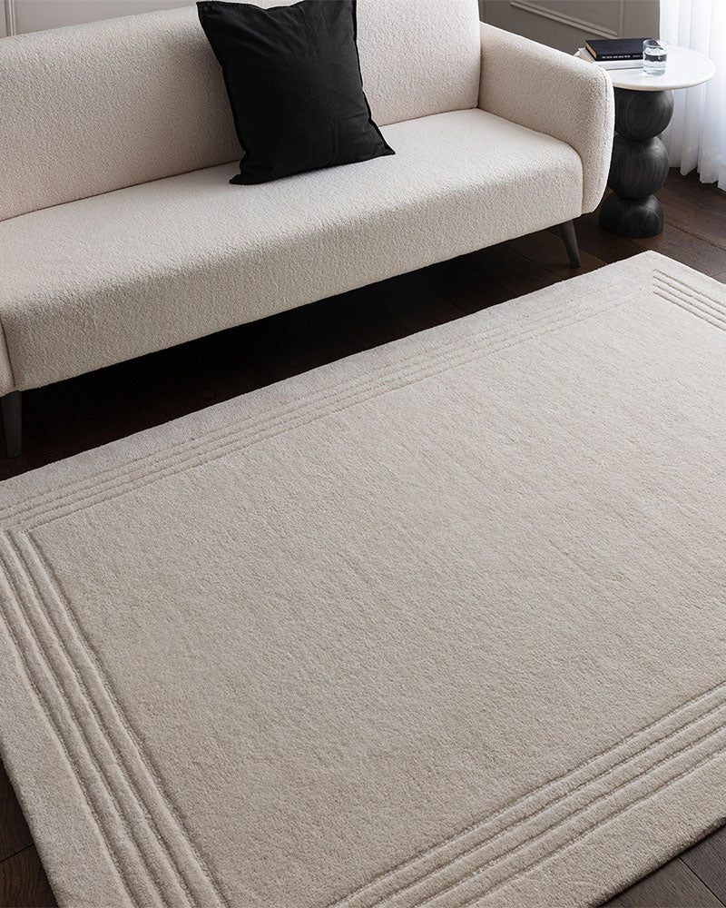 ORLO IVORY UNDYED WOOL BORDERED RUG